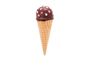 Chocolate cake pop in waffle cone for ice cream, decorated with pink and white confectionery sprinkles in the form of heart. Isolated. Picture for a menu or a confectionery catalog.