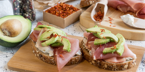 fresh bread with cottage cheese, prosciutto , avocado and saffron