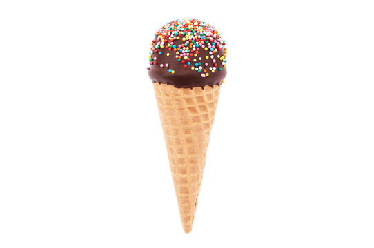 Chocolate cake pop in waffle cone for ice cream, decorated with colorfull confectionery sprinkles. Isolated. Picture for a menu or a confectionery catalog.