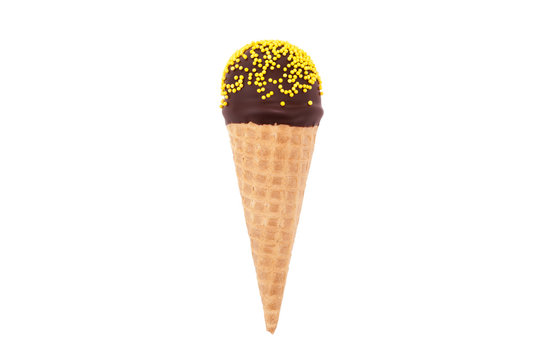 Chocolate cake pop in waffle cone for ice cream, decorated with yellow confectionery sprinkles. Isolated. Picture for a menu or a confectionery catalog.