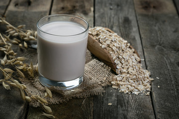 Oat milk alternative on rustic wood background
