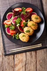 Japanese potato korokke and fresh vegetables close-up. Vertical top view