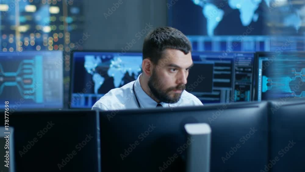 Leinwandbilder Monitoring Room Operator Observes System Stability, Rapidly Moving from One Display to Another. Screens Show Technical Data. Shot on RED EPIC-W 8K Helium Cinema Camera.