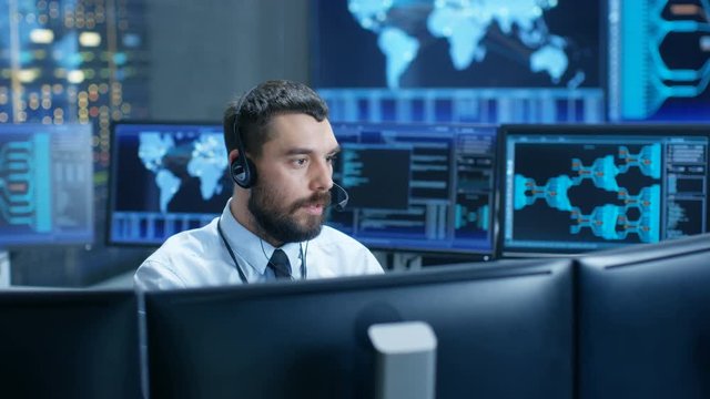 In the System Monitoring Room Dispatcher Speaks into Headset, Observers Proper Functioning of the Facility. 