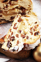 Christmas stollen on wooden cutting board. Traditional German festive baking