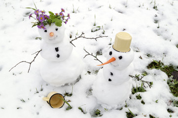 Two snowmen handmade in the snow.