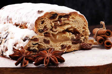 Christmas stollen on wooden cutting board. Traditional German festive baking