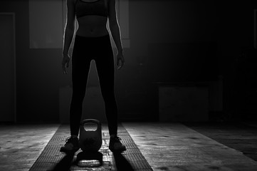 Young female doing exercises with kettlebell