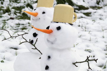 Two snowmen handmade in the snow.