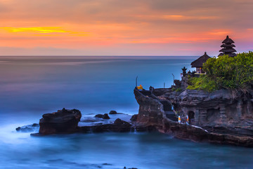 The Pilgrimage Temple of Pura Tanah Lot at sunset, island with an Indonesian shrine on the ocean,...