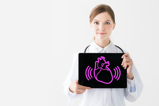 Young woman doctor showing heartbeat icon.