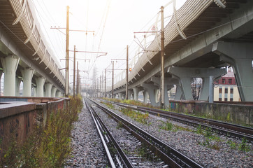 High-speed highway on high pillars at the bottom of the railway.