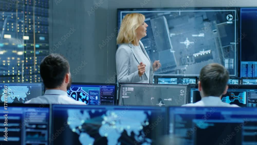 Poster in the government surveillance facility team of officers organize interception plan with help of sat