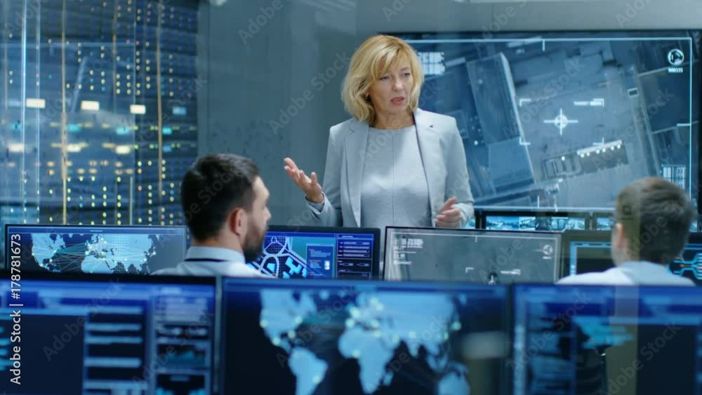 Poster in the government surveillance facility team of officers organize interception plan with help of sat