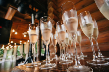 glasses with champagne wine at the reception of guests in the open hall. Celebration.