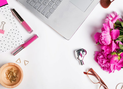 Feminine workplace with laptop and flowers