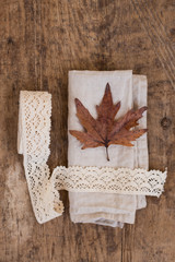 Autumn leave on cotton napkin