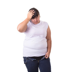 Fat asian woman trying to wear small size jeans isolated on white. Fat and Healthcare concept