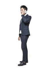 business man standing up with smart phone isolated white.