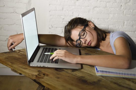 Young Beautiful And Tired Student Girl Sleeping Taking A Nap Lying On Home Laptop Computer Desk Exhausted And Wasted Spending Night Studying