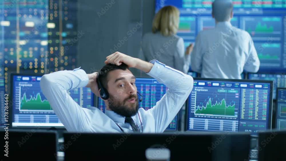Leinwandbilder Stock Exchange Trader Makes a Deal with Big Client Over the Headset. He Works with Other Brokers and is Surround By Computers with Graphs and Ticker Numbers on Screens. 