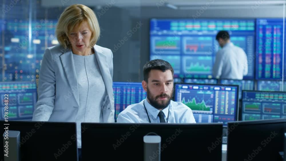 Aufkleber in the stock market firm head of the department talks with professional trader. they're surrounded b