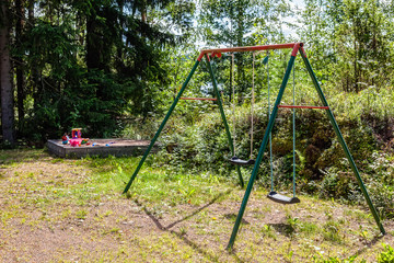 A swing and a sand pit are in the yard