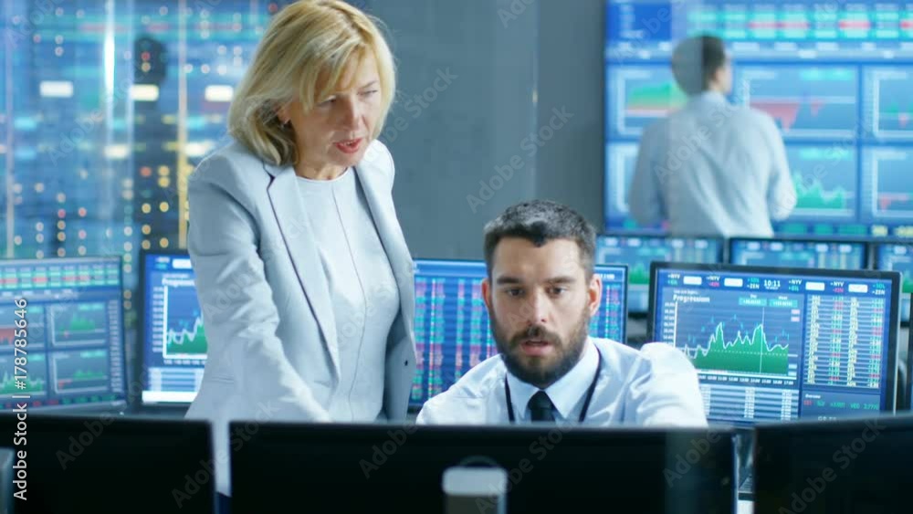 Poster in the stock market firm chief executive talks with professional trader. they're surrounded by scree