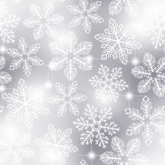 Snowflakes pattern. Seamless pattern with fluffy white snowflakes on gray background.