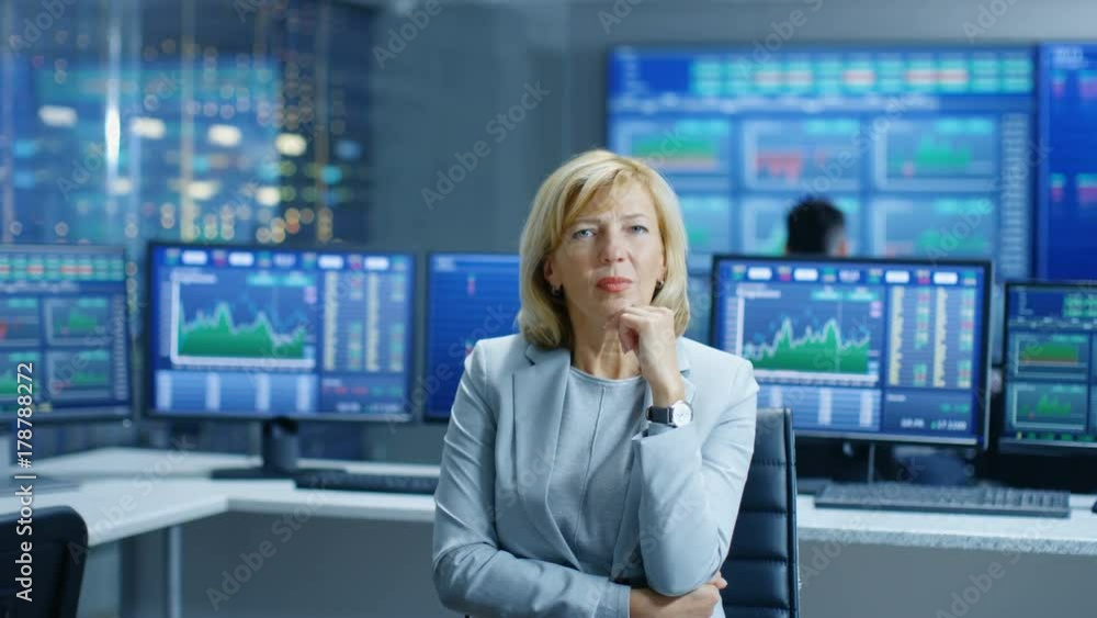 Poster stock market leading analyst thinking hard on solving financial problem. behind her people working a