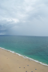 Fototapeta na wymiar Cloudy skyline on sand beach and blue sea in USA