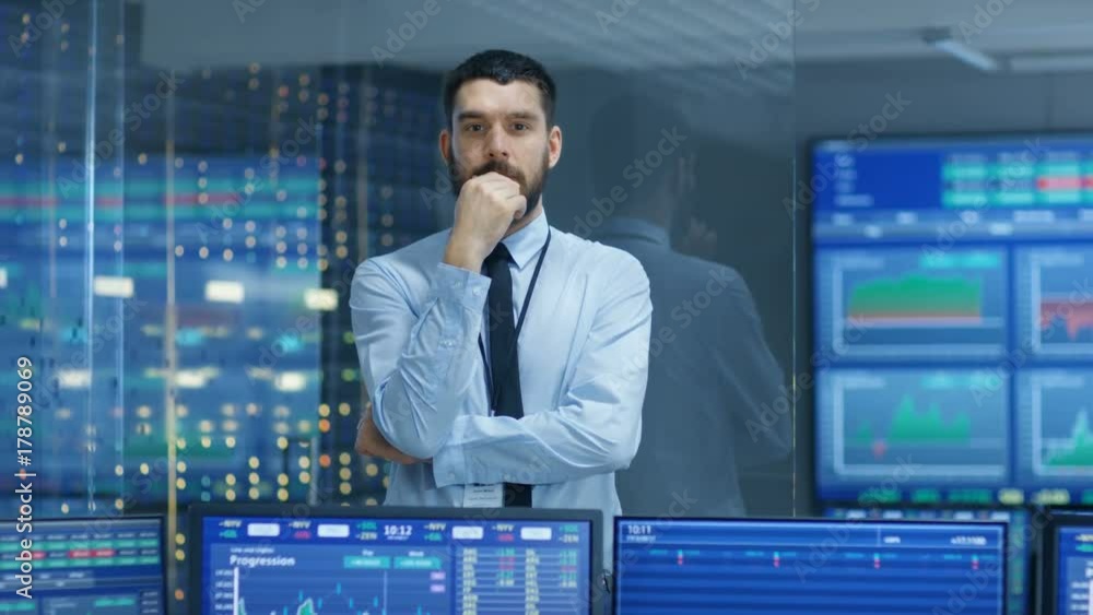 Poster stock market top trader thinking hard on selling stocks at the best time. behind him people working 