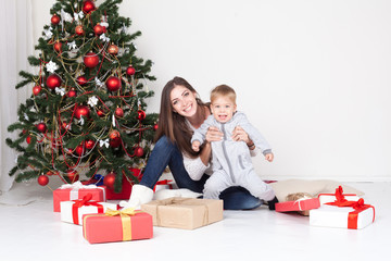 mother and son open gifts on Christmas and new year