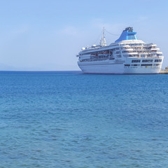 Fototapeta na wymiar Big modern luxury cruise ship docked at marina dock with sea background