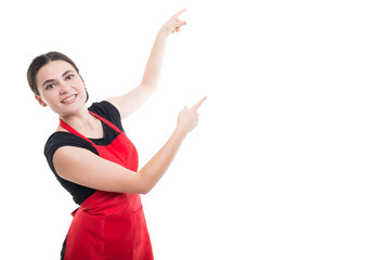 Happy smiling clerk woman pointing to copyspace