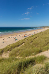 St Ives Bay beach Cornwall uk in summer with people blue sky and sea, view towards Godrevy lighthouse