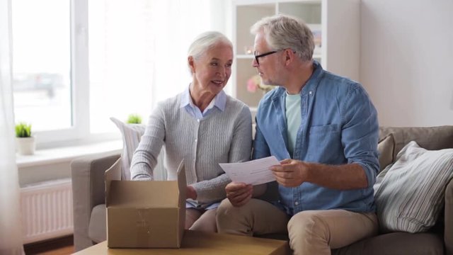 senior couple with parcel and delivery note