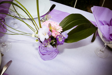 table decorated for a party or an event with green and white flowers