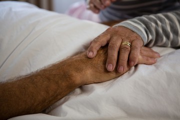 Fototapeta na wymiar Hands of senior couple relaxing in nursing home