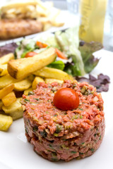tasty Steak tartare (Raw beef) - classic steak tartare on white plate