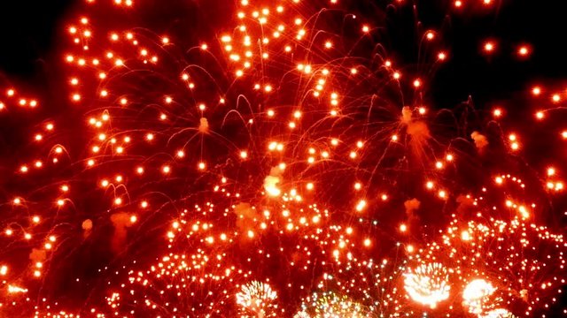 Firework display bright red at night on black background. Amazingly beautiful. Salute for new year Christmas and other holidays. Macro video closeup footage 30p.