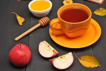 Autumn still life cup of tea, honey and book on the table