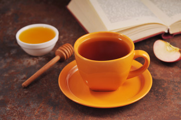 Autumn still life cup of tea, honey and book on the table