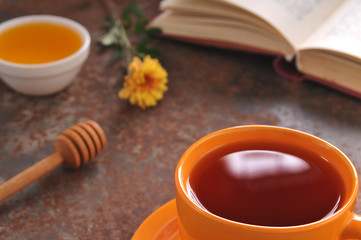 Autumn still life cup of tea, honey and book on the table