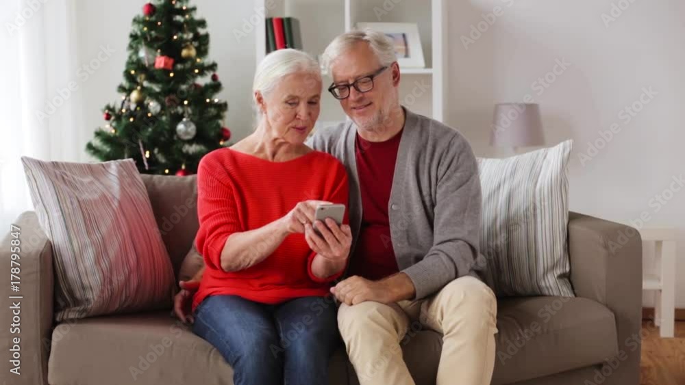 Sticker happy senior couple with smartphones at home