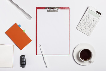 red clipboard with smart phone, stationary on the white background.
