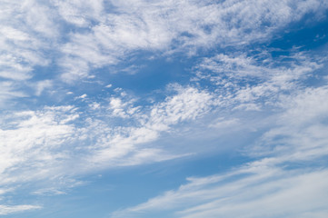 Naklejka na ściany i meble White fkuffy clouds on the light-blue sky