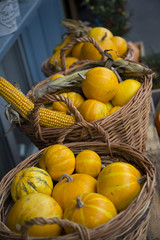Pumpkins and corn in baskets seasonal Halloween decor