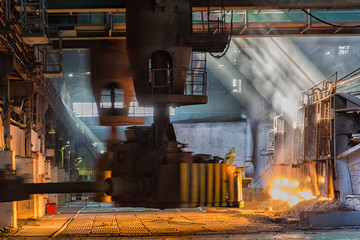 Fototapeta na wymiar Loading of ore in the open-hearth furnace at a metallurgical plant