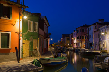 Fototapeta na wymiar Colorful houses and boats at night in Burano, Venice Italy.